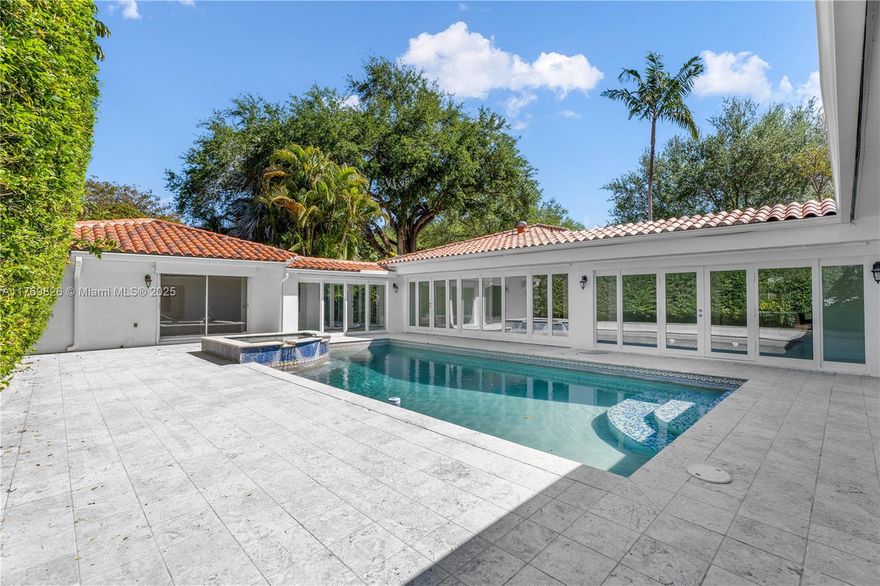 Very Rare opportunity to own a HUGE lot in South Gables! This spacious 5 bedroom home with 4,021 square ft of living area boasts one of the largest lots in the area. The home offers a split floor plan for great privacy, a sparkling pool with a whirlpool, natural stone deck, an inviting granite kitchen, and an office/den adds versatility to the layout. The exceptional location and the incredible size of this property presents endless and exciting possibilities for developers and families.