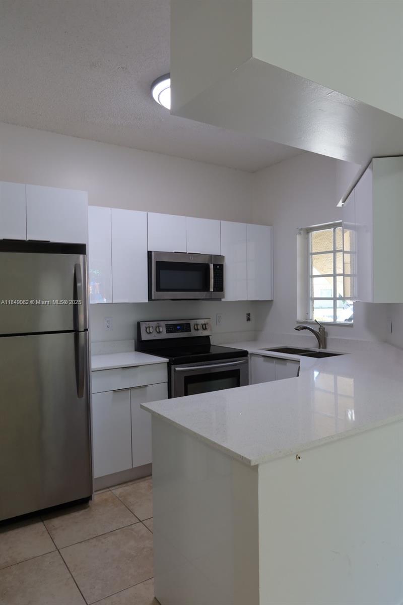 Beautifully Remodeled First-Floor Corner Unit. This 2-bedroom, 1-bath home features a private back patio, in-unit washer and dryer, and modern upgrades throughout. Move-in ready and easy to show! Water Included & 1 Parking space. Plenty of Visitors, Easy to show.