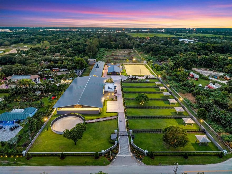 A world-class equestrian estate in Davie combining modern elegance with state-of-the-art facilities. The main residence offers 2 bedrooms, 2 baths, and a private clubhouse with bar. Inspired by European design, the property features Broward’s largest covered arena with isolation system, 5-star rated indoor and outdoor riding arenas, dressage mirrors, hot walker, treadmill, and extra-large paddocks with shaded run-ins. Forty Rower-Rube stalls connect to a full underground drainage system, ensuring no flooding. All buildings are concrete, including a luxury two-story residence and clubhouse, three-story staff housing, with direct access to Davie’s trail system and Vista View Park.