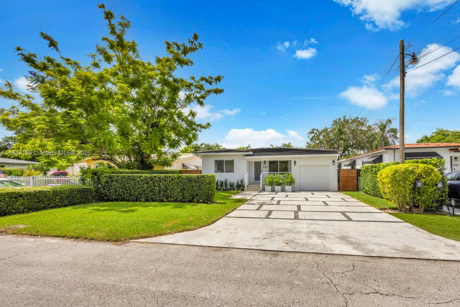 Beautifully updated 3BR/2.5BA home with saltwater pool on a 7,500 SF lot. Features include impact windows/doors, hardwood floors, vaulted ceilings, and a designer kitchen with open shelving and modern finishes. The open layout is filled with natural light throughout. Spacious primary suite with walk-in closet and spa-style bath. Private backyard with lush lawn, pool safety fence, outdoor half bath, and a covered terrace—perfect for entertaining. Two A/C units for zoned comfort. Garage has built-in storage and mini-split A/C, ideal for gym or flex space. Sprinkler system, newer roof (8–10 yrs), and HVAC (3–5 yrs). This move-in-ready home blends timeless design with modern upgrades in a quiet, family-friendly neighborhood.