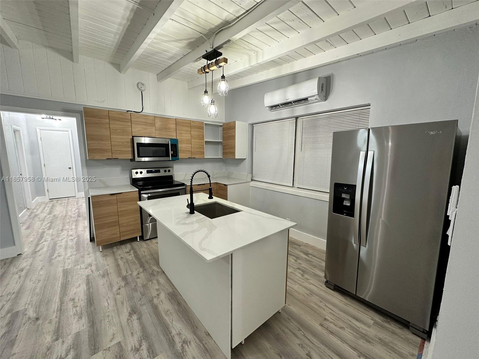 Charming and fully remodeled home in the heat of the Florida Keys!! Step inside to find an inviting open kitchen concept with updated stainless-steel appliances, wood cabinetry, quarts countertops, plenty of natural light, laminated wood flooring throughout the beautiful home and washer and dryer included. The home is located on an excellent street in a neighborhood with great homeowner's park access. The backyard is fenced and has a large storage shed.
