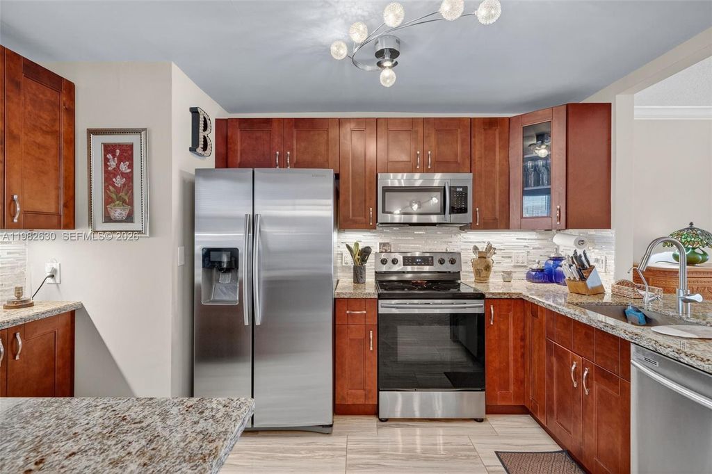 Photo of 121 Golden Isles Dr #205, Hallandale Beach, FL 33009 (MLS # A11982630)