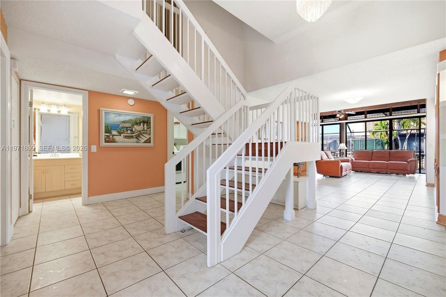 Experience Modern Resort Living in Flamingo Villas! Step into this stunning upgraded 3 bedrooms with 3 full bathroom corner residence in the heart of Pembroke Pines. This move-in-ready home features an open-concept layout with vaulted ceilings and an abundance of natural light. The kitchen boasts sleek granite countertops, and stainless steel appliances. Peace of mind allows you to relax on your private, screened-in patio with water views—perfect for morning coffee or evening BBQs. Located in a 24-hour guard-gated community with a driving patrol and low HOA, you’ll enjoy world-class amenities: 2 pools (one heated), a gym, steam room, sauna, tennis & pickleball courts, and indoor racquetball. Minutes from I-75, restaurants, shopping and fun activities for the whole family! Property also has one full bathroom and one bedroom located on the first floor! This move-in-ready corner unit truly has it all! Seller provides $10,000 credit at closing!