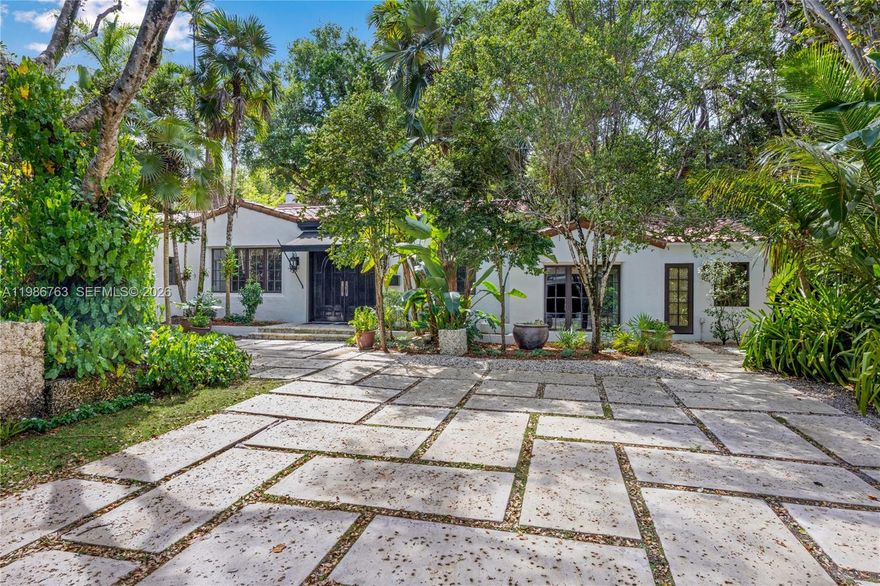 Located in the prestigious heart of South Coconut Grove, this extraordinary 2,733 square foot, 4 bedroom, 3 bathroom home exudes 1930’s charm, but with updates fit for the modern buyer!  The double-door entrance leads to a stately foyer with coral rock floors opening to the spacious eat-in kitchen with center island, new stove, and stainless steel appliances.  To the opposite side of the foyer sits the fabulous living room with vaulted wood-beamed ceilings with skylights, stunning fireplace, and cozy office nook with built-ins.  The split floorplan includes 2 bedrooms as well as the stunning primary suite with sitting room, walk-in closet, elegant bathroom, and pool views to one side, while an additional bedroom/bathroom is privately located on the other side of the home.  The 8,064 square foot corner lot is landscaped with native plants, oolite stone borders, gracious outdoor living areas, and a stunning tropical pool.  Other special features include impact glass throughout, generator, beautiful vintage tile, stone, and wood flooring, and so much more in Miami’s most desired neighborhood.