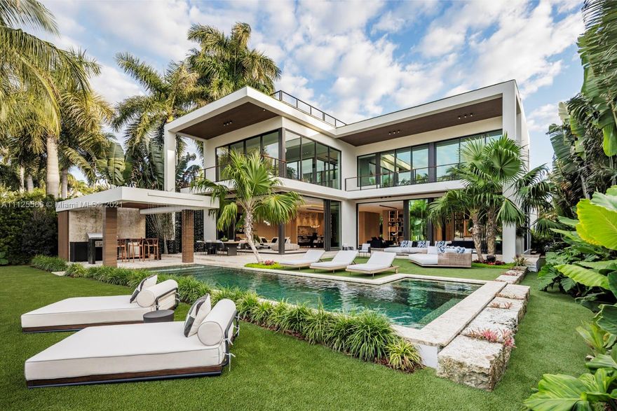 The artistic expression of fine living, this extraordinary estate on Sunset Island III was recently completed to the highest level of fit and finish. Take in sublime sunset views from the new dock just off the bay, with 75 feet of water frontage, located walking distance from Sunset Harbour. The 8,500 total sq. ft, house has magnificent indoor/outdoor entertainment areas within an oasis of green, a saltwater pool with water curtain and hot tub, an artistic chef’s kitchen with cantilevered island, a soaring atrium, a library with wet bar, and an elevator to the rooftop terrace. The bespoke master suite offers a spa-like bath and meditation courtyard. White oak floors, micro cement walls, and unique cuts of travertine add texture to the modernist home, which is furnished by Minotti.