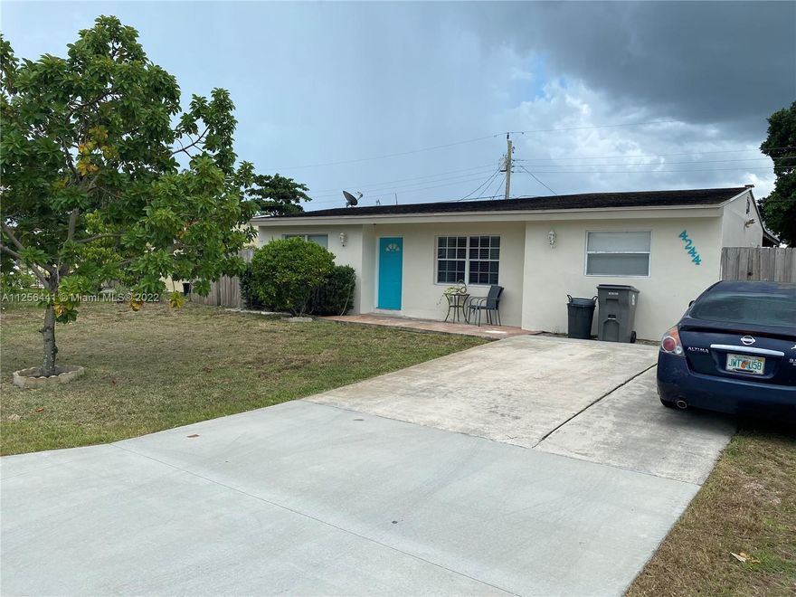 This is an amazing opportunity to own a home in this quiet, clean and secluded neighborhood. The home features 3 bedrooms and 2 bathrooms although it is divided in order to make extra income into a 2/1 and a 1/1 with a private entrance. Buyer can decide to change it back or keep it the same and make around $1,100/M extra. The current tenant will vacate at closing. Both bathrooms have been remodeled, kitchen updated, stainless steel appliances and newer AC system. There is a very big back yard with a fence with enough space for a pool or extra living quarters if wanted. This home is located close to everything. 5 min to palm beach international airport, 3 min to Berkshire elementary, 5 min to palm springs middle school, 5 min to I95, 15 min to WPB downtown and close to shopping malls