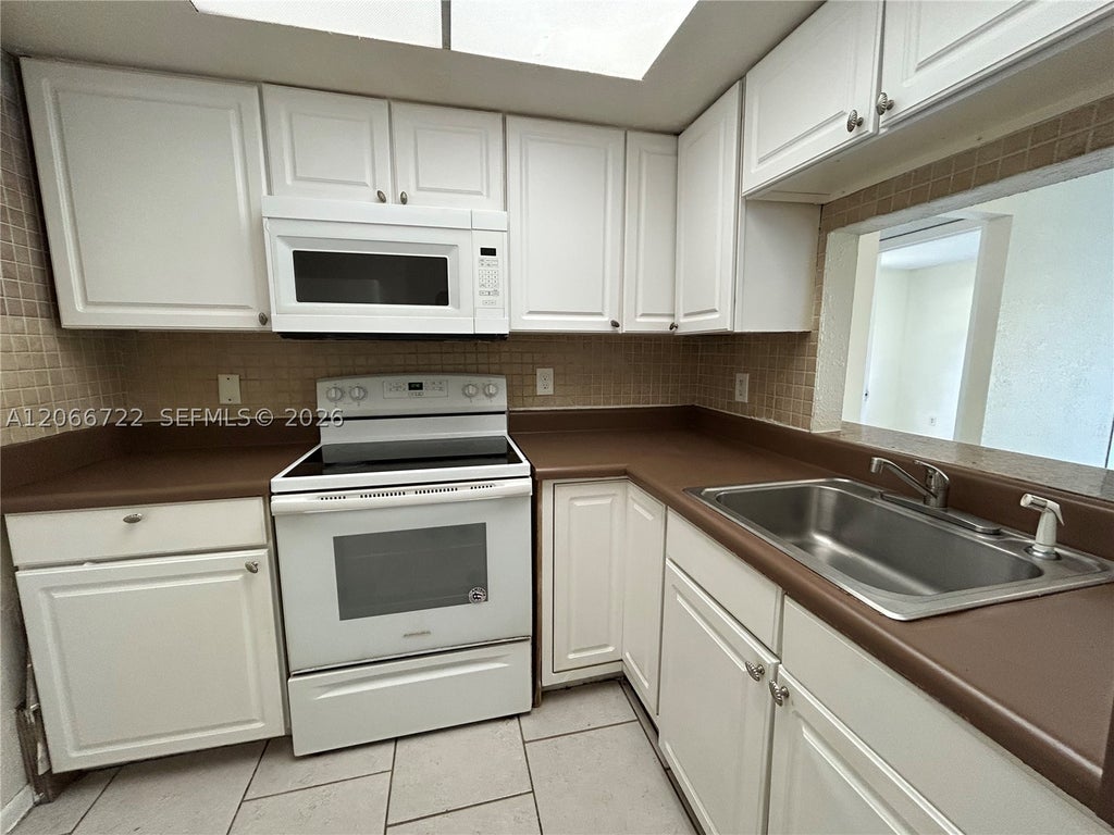 Photo of 7625 Tam Oshanter Blvd #102-2, North Lauderdale, FL 33068 (MLS # A12066722)