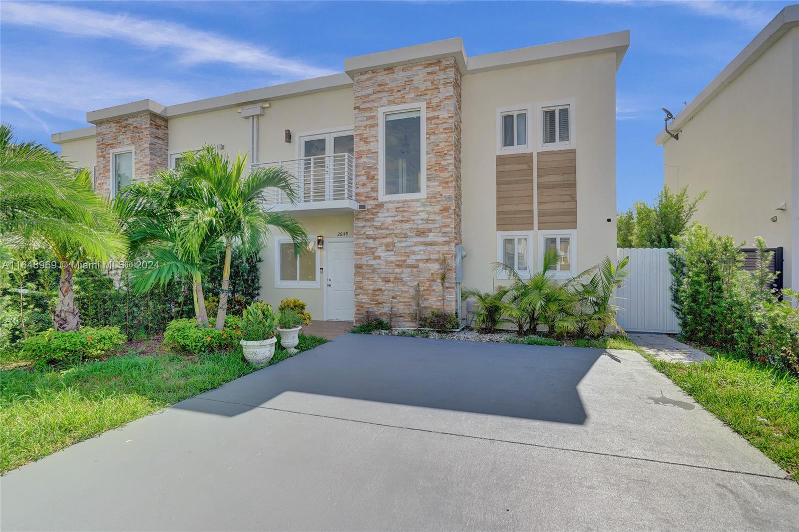 Move-in ready townhome with 3 bedrooms and 2.5 bathrooms, conveniently located near the Turnpike in Homestead. This bright and updated home features an upgraded kitchen and bathrooms, impact windows, and tile flooring throughout. Enjoy a large patio with a yard, complete with a mango tree, perfect for outdoor relaxation. A special water filtration system is installed for your convenience. No association application required – move in quickly!