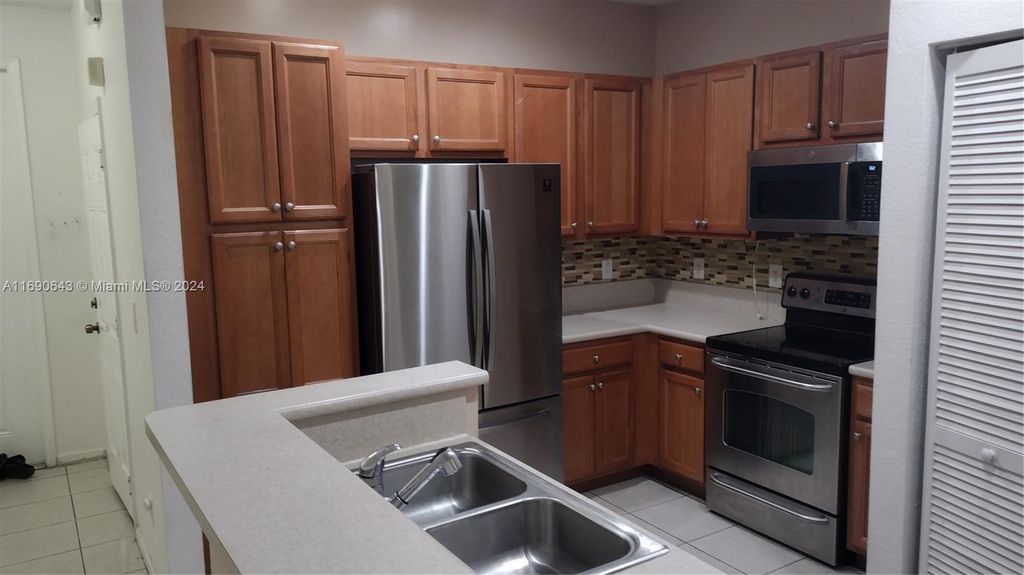 Photo of 6808 Cypress Walk Ter, Tamarac, FL 33321 (MLS # A11690643)