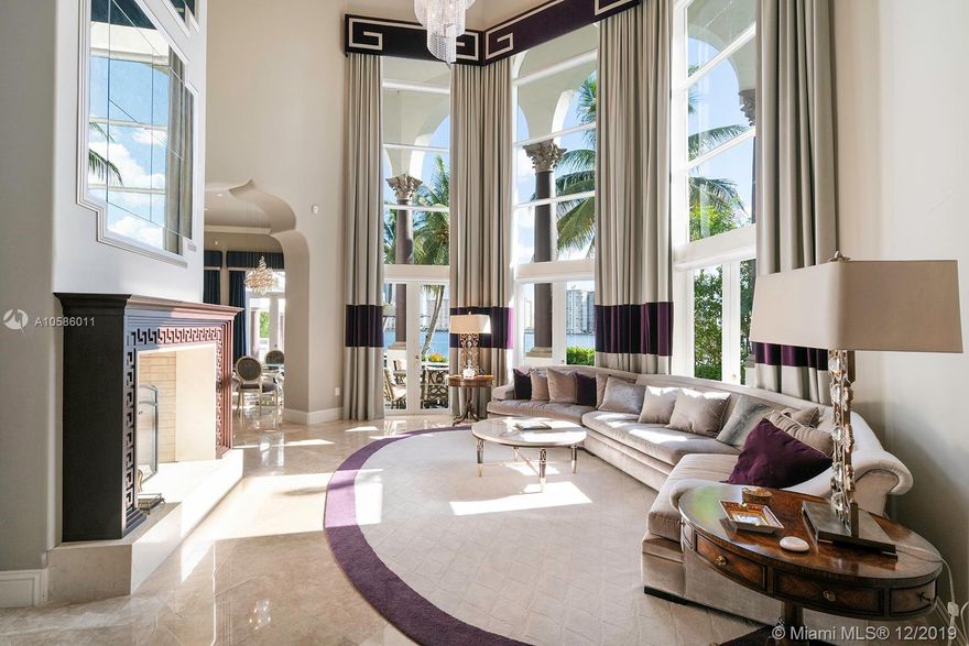 Stunning masterpiece bayfront home with incredible attention to detail in the prestigious gated community of Island Estates. The only home on a double lot of 24,772sf with 240ft of water frontage. Top of the line finishes, vaulted 30 foot ceilings, gourmet chefs kitchen, elevator, luxurious master suite with sitting area and veranda with sunrises and sunset panoramic views. Stunning tropical pool and spa overlooking the bay. Marble and walnut hardwood floors, impact glass, 50ft boat docks with electric and water. Ipad controlled smart house system, movie theater with 128 inch TV, cabana, elevator, office, service quarters and golf cart parking. and 14K Gold Chandeliers with Swarovski Crystals with a special cleaning system. Residents have complete access to Prive five star amenities.