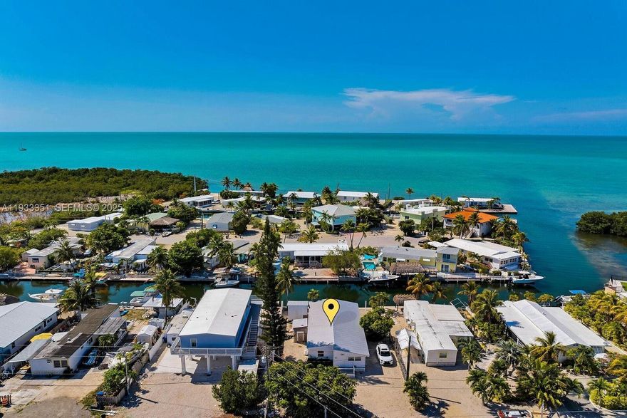 Looking for a no-frills Florida Keys escape with unbeatable dockage? Welcome to your ultimate fish camp in Grassy Key! This standalone home with no HOA offers instant bay access and quick ocean access from a 60-foot deep-water dock. A large exterior storage building is perfect for all your gear. Inside, the home is spacious and has been updated with new electrical, a new water heater, brand-new doors and windows and a newer metal roof (2020). Tucked away in the quieter part of Marathon yet easily accessible off US-1, it's the ideal weekend or winter retreat for boaters and anglers.