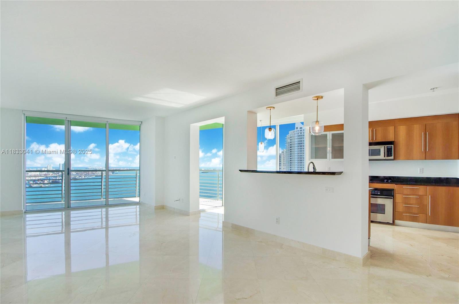 Remodeled 3bed/2bath with breathtaking unobstructed water views from every room, wraparound balcony, SS appliances, granite countertop & 1 assigned parking space on 3rd floor! Second bedroom also opens to the living room with double doors. Marble floors in common areas including balcony and also in the 2nd bedroom & vinyl floors in other rooms. Open kitchen with breakfast area, modern bathrooms & built-in walk-in closets. Amazing location, near Whole Foods, Bayfront Park, Arena & Brickell. Close to the I-95 entrance! Balcony ceiling is now white.