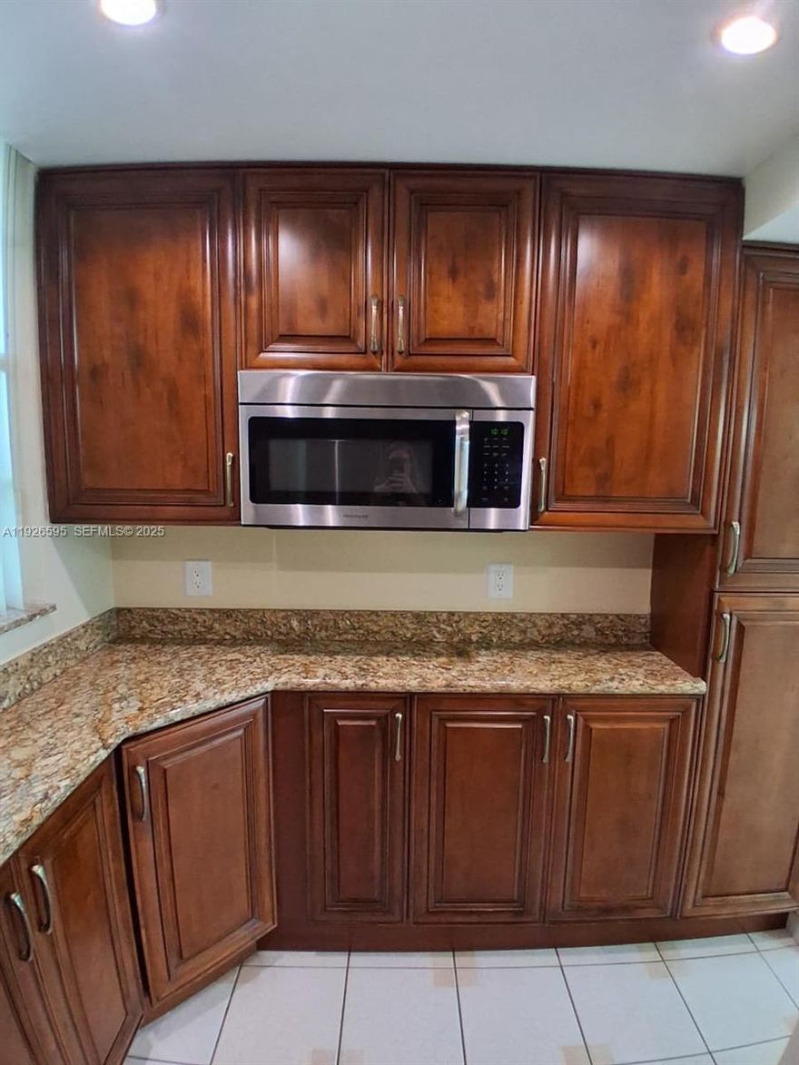 Great Community! Serene views! Private Guard Gated Community.  Ready to move in! Tile floors throughout, this unit has a one full bathroom and a half bathroom, tastefully decorated. Beautiful Kitchen cabinets, granite countertops and updated appliances. 55+ community. Great walking areas, swimming pools throughout! Guest parking space in front of this building allowing short walk to the bldg. Washer & Dryer on the same floor! Small bowling ally and lots of amenities in the club house!