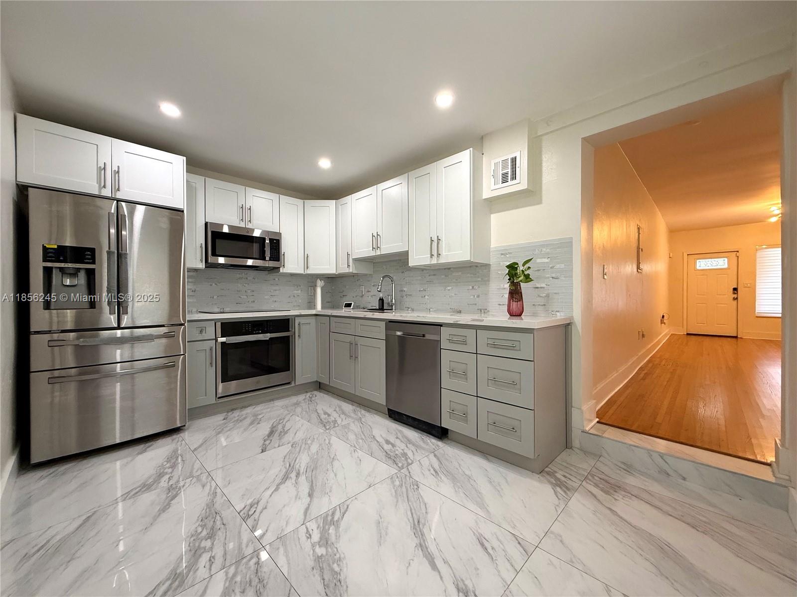Beautifully updated single-family home with modern finishes and a prime location on a main street Coral Way. This light-filled residence features an updated kitchen with marble flooring, sleek countertops, and new appliances, plus warm laminated wood flooring throughout the living areas. Enjoy a spacious backyard with a cozy sitting area, perfect for relaxing or entertaining. Parking driveway included. Please note: in-law quarter is occupied and not part of the rental — separate entrance and parking provided for both units. Owner covers utilities of internet, water, and electricity. Excess electricity may be subject to be billed seperate from base rent. Please inquire if any questions.