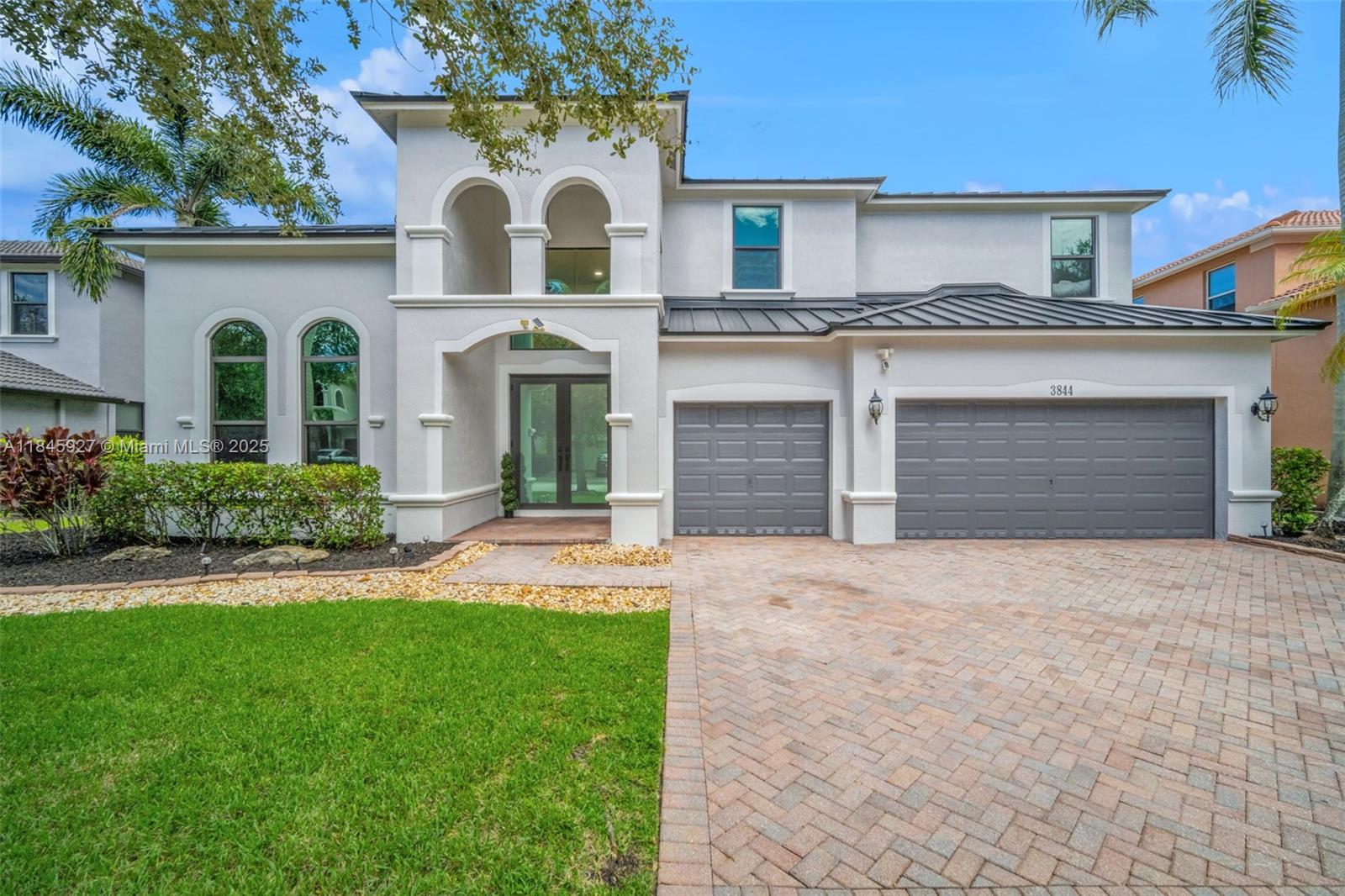 This showstopping, one-of-a-kind home is filled with upscale upgrades and eye-catching style! With 5 spacious bedrooms, a private office, and a flexible loft. all offering stunning lake views — Brand-new 2024 metal roof and lush landscaping. Inside, soaring ceilings, a statement staircase, and sleek modern flooring create a grand welcome. The gourmet kitchen wows with a wine display, premium appliances, double ovens, and an oversized island. The primary suite offers a relaxing sitting area and spa-like bath with soaking tub. Enjoy the Florida lifestyle outdoors with a screened patio, summer kitchen, sparkling pool, & cabana bath. Located in the prestigious gated Isles at Weston, with a renovated clubhouse, resort-style amenities, and top-rated schools. This home isn’t just updated