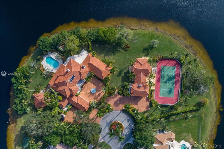 Nestled on a cul-de-sac in the Exclusive Guard Gated Community of Windmill Ranch Estates. This Magnificent Estate Sits on Nearly Three Waterfront Acres. Reminiscent of a Tuscan Villa, w/3 Separate Structures. The Main Home, Guest Home & Family Lodge that is Adjacent to the Sunken Tennis & Sport Court. As You Arrive, The Impressive Entry Warmly Greats You. Nine Resplendent Bedrooms, All of which are Ensuite & Nine + Two Half Bathrooms. The Entire Estate & Grounds were Meticulously Planned & Thought Out. The Build Quality & Details are Extraordinary for which this Home has Recieved Numerous Awards. Additional Features include a Grande' Backyard w/Spacious Lounge Areas, Theater & Billiard Rooms, Library, Chef’s Kitchen, Butler’s Pantry, Staff Quarters, Home Gym, Six Car Garage & Motor Court.