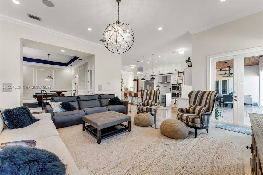 Newly remodeled, turnkey masterpiece is nestled in the prestigious Triple Estates neighborhood of Palmetto Bay, one of South Florida's most coveted addresses. From the moment you step inside, high-end finishes and thoughtful design details make it clear that no expense was spared.

Elegant formal living and dining rooms flow seamlessly into the crown jewel of the home: a show-stopping chef's kitchen boasting a massive center island, premium appliances, and a fully concealed prep kitchen; an entertainer's dream and a culinary enthusiast's paradise. The expansive family room offers the perfect backdrop for gatherings of any size, while the generous billiard room, easily large enough to accommodate a regulation-size pool table, presents exciting versatility to convert it into a 5th bedroom, private home office, or media room, offering a flexible space to suit your lifestyle.

The gorgeous primary suite is anchored by a spa-inspired bathroom adorned with luxurious sky-blue porcelain tile, marble accents, and a double vanity that radiates five-star elegance.

Outside a fully fenced backyard oasis, thoughtfully designed for ultimate privacy with ample space to park your boat, a rare find in this community.

All of this, just minutes from the scenic waterways of Deering Bay, with easy access to nature trails, jogging paths, bike routes, and a golf cart-friendly atmosphere. Top-rated schools round out this extraordinary opportunity.

This is the one you've been waiting for!