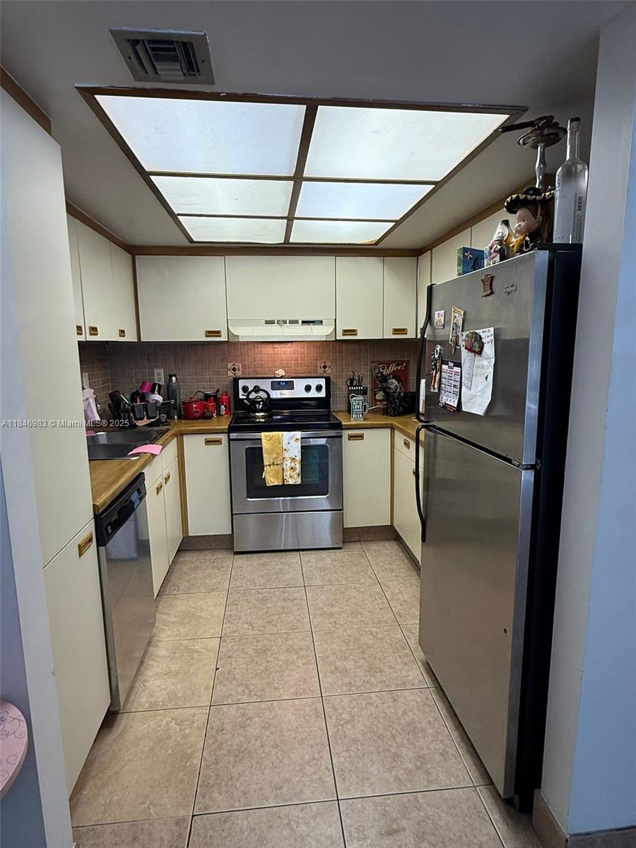 Spacious 2 bed, 2 bath second-floor unit featuring tile floors throughout, a modern kitchen with ample cabinet space, and a private screened balcony perfect for relaxing. Enjoy an open living/dining area, generously sized bedrooms, and plenty of natural light. The primary suite offers a large closet and ensuite bath. Community includes laundry facilities and green space. Centrally located near shops, restaurants, and major highways. Move-in ready!