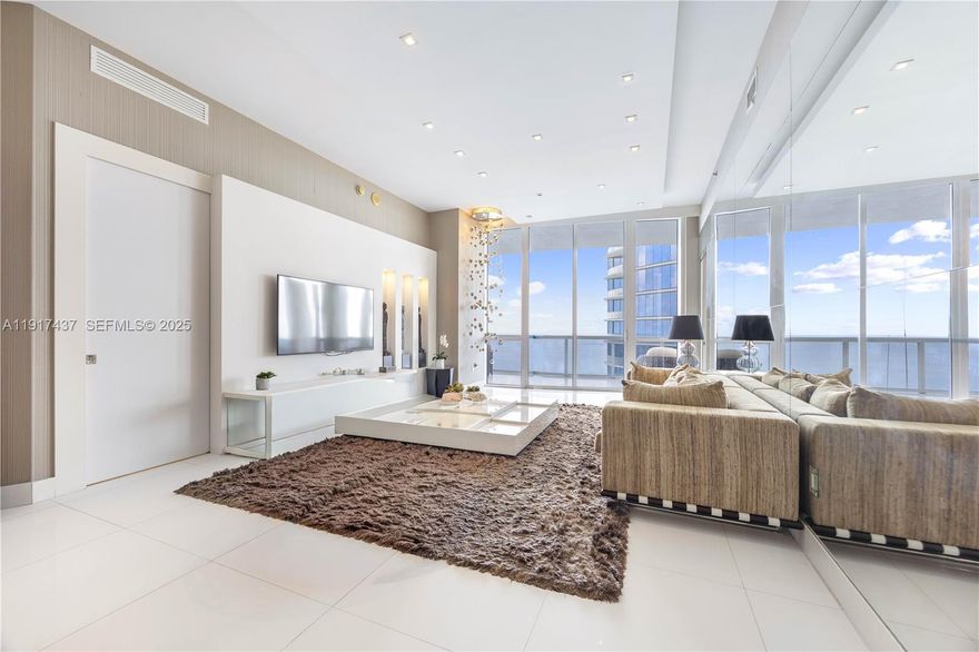 High floor, direct oceanfront, fully furnished residence in the highly desirable 07 line at Trump Tower III. This 2 Bedroom + oversized Den with en-suite Bath (lives as a 3rd Bedroom) offers a private elevator entrance and foyer, 11-ft ceilings, and floor-to-ceiling impact glass with direct ocean, Intracoastal, and Miami skyline views. Spacious living and dining areas flow seamlessly toward the terrace, creating a bright, open layout ideal for everyday living and entertaining. The living room is adorned with a custom TV wall, custom light fixtures, and decorative wallpaper. The primary bedroom offers direct balcony access, a large built-out walk-in closet, and an impressive spa-like bathroom. The second bedroom's closet was expanded, as was the den's, which both include their own en-suite bathrooms, offering true bedroom functionality. All bathrooms are finished with contemporary fixtures including floating vanities, marble floors, and glass-enclosed showers. Additional interior features include walk-in closets, built-ins, walk-in laundry room, and a large primary suite with separate tub and shower. Flooring is luxurious travertine throughout. Residents enjoy direct beach access with full chair/towel service, heated oceanfront pools, seaside restaurant with room service, fitness center, spa, business center, clubroom, concierge, and valet. A high-floor beachfront residence with panoramic views and modern upgrades in one of Sunny Isles’ premier towers.