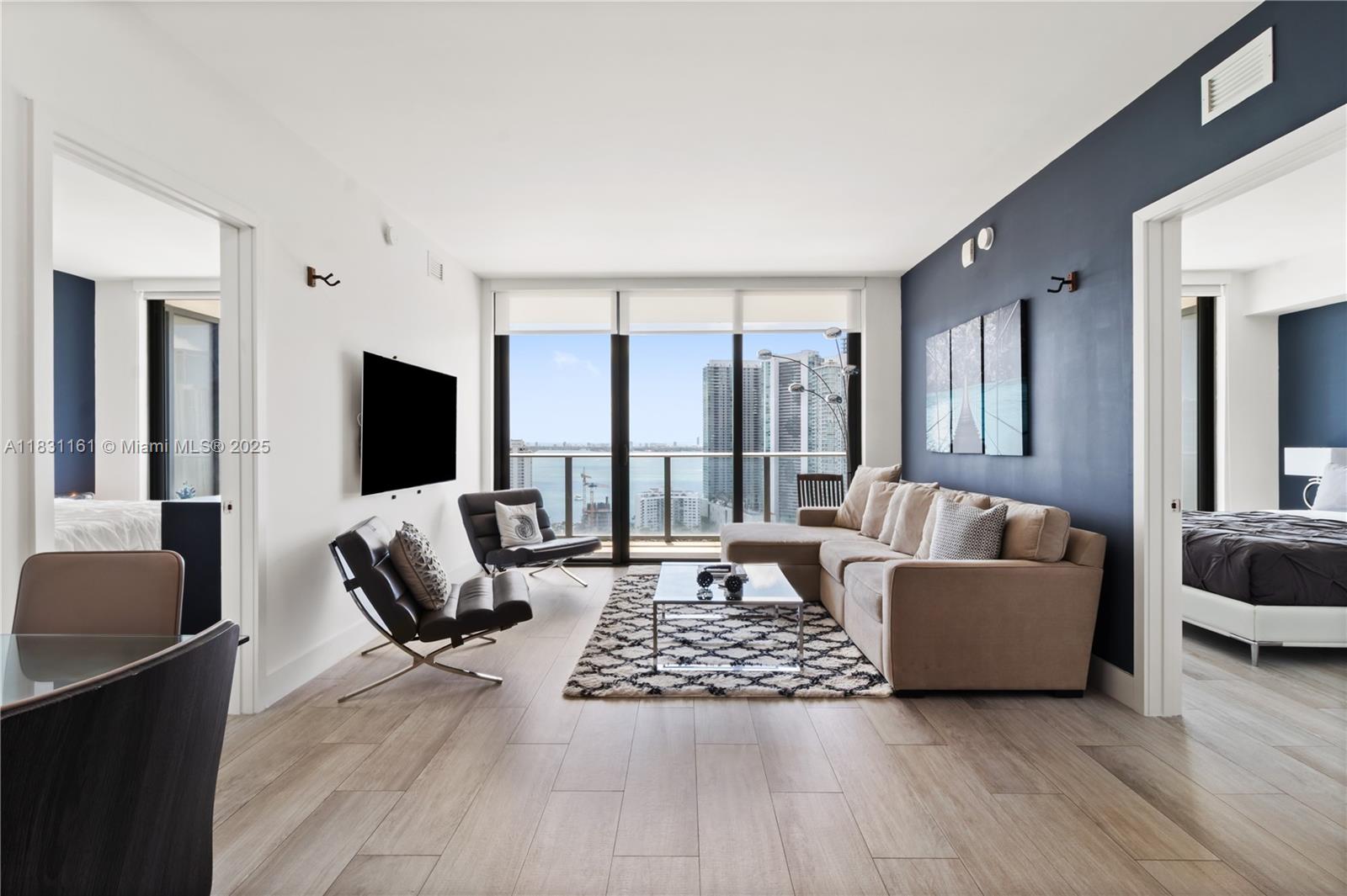 Available for Rent, either short-term 30 days minimum and long-term 1 year lease, this stunning condo in Hyde Midtown offers breathtaking sunrise views of Biscayne Bay and the Miami skyline from every room. Featuring 2 bedrooms, 2 bathrooms, and a versatile den, the unit is fully furnished and thoughtfully designed for comfortable, upscale living.
Enjoy resort-style amenities including 24/7 concierge services, a full-service spa, state-of-the-art fitness center, pool, tennis court, and an on-site bar-restaurant. Perfectly situated in a walkable neighborhood just steps from the Miami Design District, and only minutes from South Beach and the airport. Experience luxury, convenience, and vibrant city living all in one place. Call listing agent(s) for showing!
