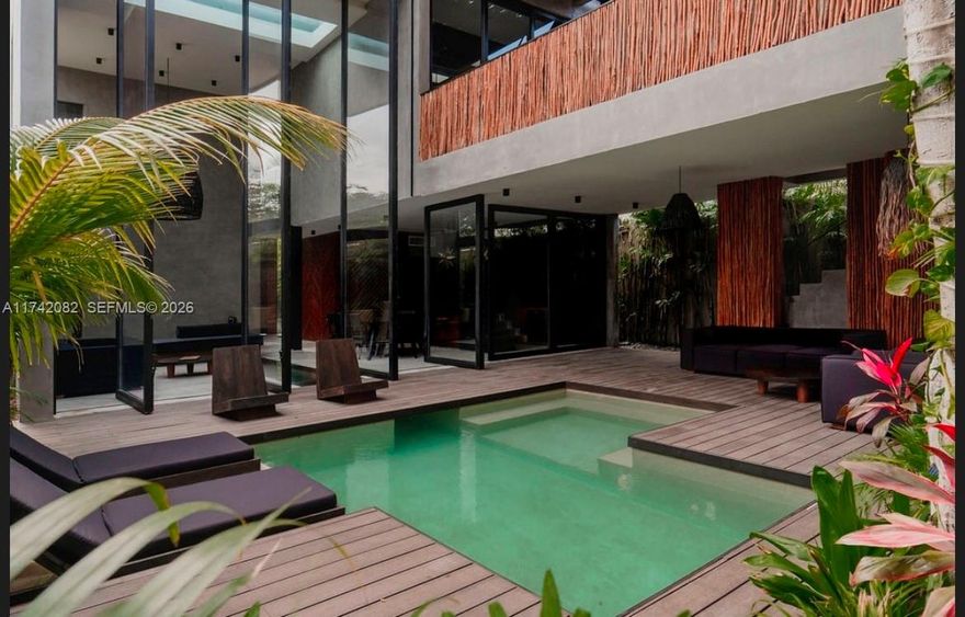 Villa Niburu is a luxurious and comfortable home located in the heart of Tulum. It features brand new, fully equipped and furnished spaces with a unique and minimalistic design. The villa boasts a glass bottom rooftop pool that overlooks an outdoor terrace and has a glass side that allows guests to peek into the kitchen and living room. The property has been designed with top quality materials and offers extreme comfort. The villa also includes a private pool, rooftop terrace, sun beds, security, and a rooftop dipping pool with views of the Mayan jungle. Villa Niburu is an excellent choice with its high-quality amenities and excellent return on investment.