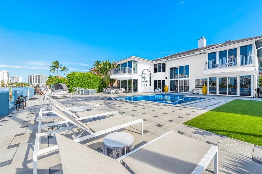 ( home is currently painted blue :) ) A completely custom, Just renovated one of a kind magnificently created waterfront mansion in the heart of Seven Isles, Ft. Lauderdale, the yacht capital of the world. Direct intracoastal, open water views from every room. No expenses spared in this timelessly designed home featuring a grand double height entryway, amazing floorplan, oversized rooms, and a chefs kitchen. Giant pool and jacuzzi overlooking the open waterways, offered turnkey and furnished.