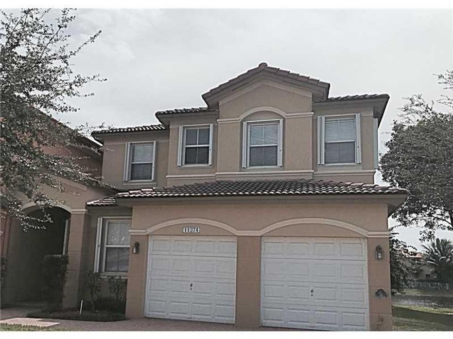 Magnificent and relaxing lake view property. Beautiful corner townhouse in one of the most desirable communities in Doral. 4 bedrooms / 3 bathrooms, kitchen and bathrooms upgraded, ceramic floors and accordion hurricane shutters. Terrace with pavers and a utomatic awning. Many upgrades and barely lived in. 1 bed, 1 bath on first floor.  Low monthly fee of $245. Includes access to club house, pool, gym, tennis & basketball courts and more. Security patrol at night and 24hr alarm system. Easy to show. As-is.