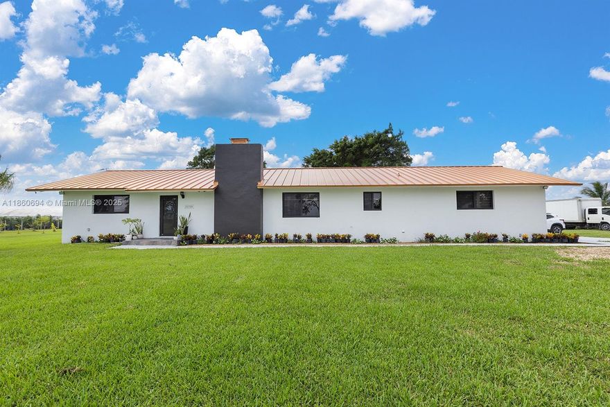 Unwind in your private Redland retreat! Conveniently located minutes away from the City of Miami, this custom-built 1980s home features 4 beds & 2 baths, including upgrades like a NEW METAL ROOF, IMPACT WINDOWS & DOORS AND 2 NEW A/Cs. Step inside to an open-concept living area, featuring a large kitchen that flows into living spaces and a fireplace. Unwind and soak in the Florida sunshine by the sparkling pool and indulge in the outdoor Jacuzzi. Imagine strolling through your nearly 5-acre oasis, most of which is a thriving lime grove! A spacious open 40x60 pole barn provides ample storage and a RV pad with sewer and electrical hookups. Enjoy the tranquility of country living & nature, while still being just a short drive from Miami’s vibrant culture and the scenic road to the Florida Keys
