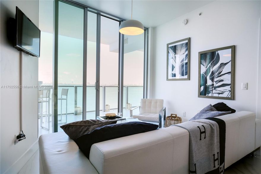 Absolutely gorgeous, COMPLETELY FURNISHED (MODANI) AND DECORATED. Amazing open water views from one of the best buildings in Edgewater, open balcony, 2 bedrooms with 3 full bathrooms, porcelain flooring throughout. Large balcony, stainless steel appliances, European kitchen cabinets, floor to ceiling windows. Full amenities include: fitness center, two tennis courts, spa, pools, cabanas, club bar, business center, sauna, outdoor fire pit, sand volleyball court, concierge, valet for guests. one covered assigned parking.