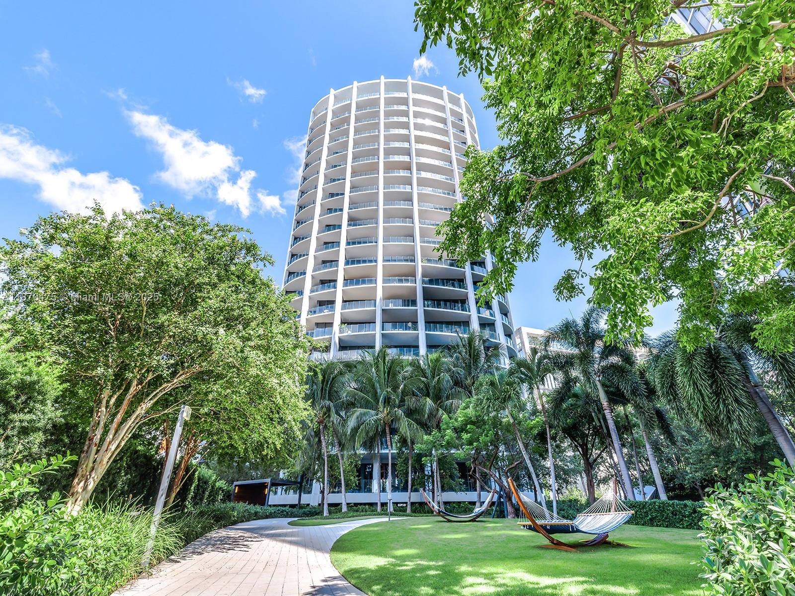 Live the ultimate Miami lifestyle in this 3 bed / 3 bath residence at Park Grove, Coconut Grove’s premier address. Soaring 12 ft. ceilings and an expansive balcony—the largest in the complex—set the tone for indoor-outdoor living surrounded by lush gardens. Upgrades include a custom pantry, laundry room, and soaking tub. Interiors feature Wolf and Sub-Zero appliances, premium finishes, and elegant details. With two master bathrooms, this home offers exceptional comfort and flexibility. Park Grove boasts 50,000 sq. ft. of resort-style amenities including pools, spa, fitness center, wine lounge, screening room, and concierge services. Steps from Biscayne Bay, top dining, CocoWalk, marinas, and Miami’s best schools, this residence blends tranquility with the vibrant energy of Coconut Grove.