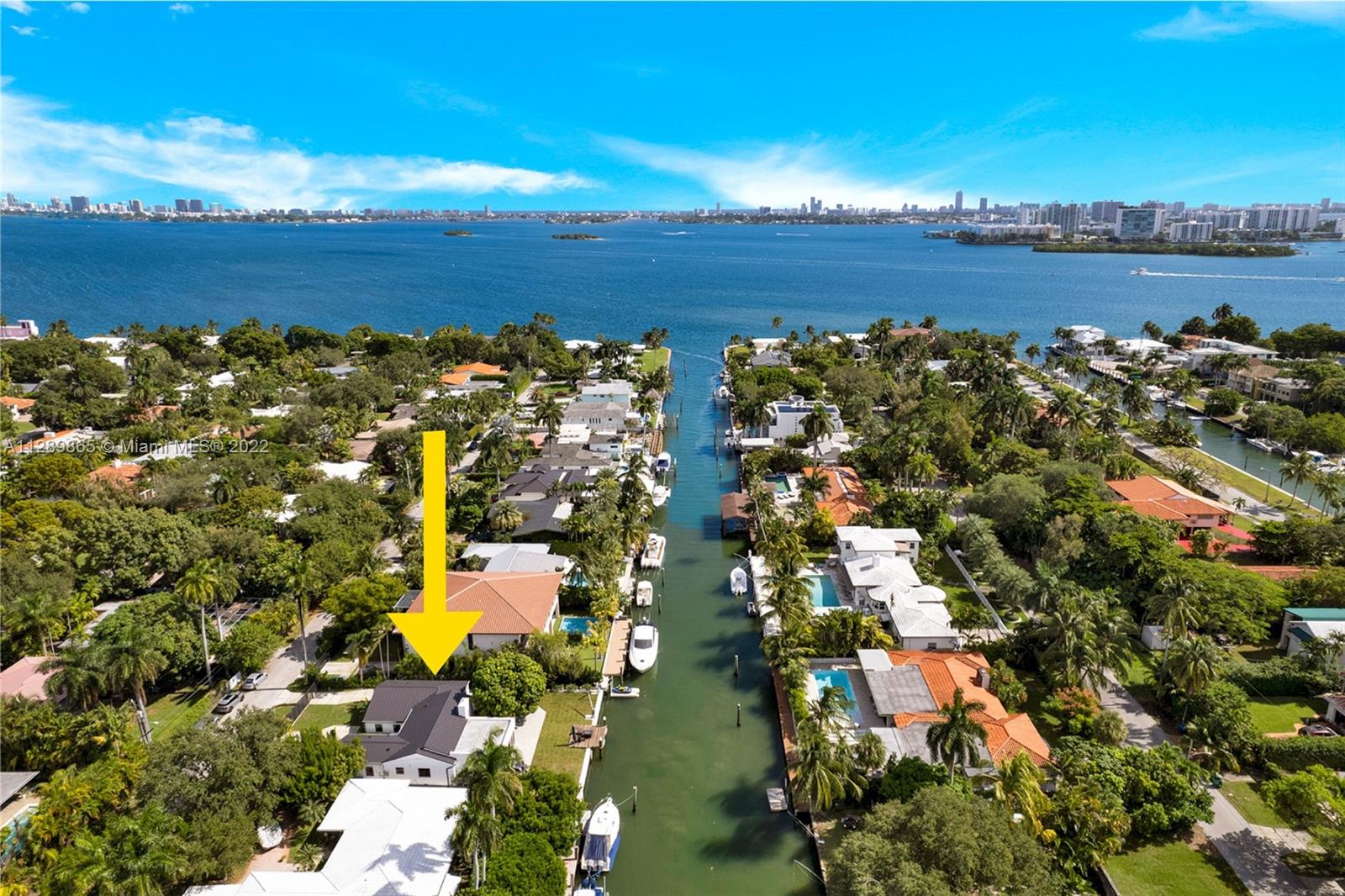 Boater's Dream! Bring your boat to this pristine, modern Mediterranean waterfront home, like new construction! 75ft of waterfront, just houses away from the open bay, no fixed bridges. Completely renovated in 2020, new metal roof in 2021. This total turn-key home boasts 4 bedrooms and 3.5 bathrooms with lots of natural light. Updates include plumbing, electrical, new a/c units, driveway with automatic gates, dock, impact windows and doors and fresh, new landscaping. Vaulted ceilings in the living and kitchen, new appliances and alarm system. The beautifully maintained backyard features patio dining space, mature trees and room for a pool. This hidden gem is a must see! Highly sought after location- close to Miami Beach, Midtown, Wynwood and Miami International Airport.