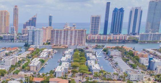 Rare waterfront corner unit / 55+ Association—only 1 of 7 ground-floor units with a wraparound screened terrace and East-SE water and boat docks views. Seller financing available: 40% down, 6% interest-only, 5-year balloon. Building features newer roof, concrete restoration, upgraded elevator, 50-yr cert. approved. Tile floors, granite kitchen w/pass-thru, custom blinds. Upfront Parking space #27. Seller to pay current assessment at closing. Storage & laundry nearby. Rentals after 1 year. Amenities: clubhouse, new gym, 3 pools, game rooms, 24/7 guard gate. Free NMB trolley. Walk to shops, beach, Oleta Park, & movies. Easy to show / Short notice okay / Call Randy Rose