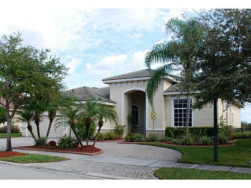 Expansive layout w/ central living room; glassed wall w/ covered patio overlooking lake; split design w/ large master suite & spacious den/office on one side; three bedrooms on other side of home; large island kitchen w/ eat-in counter; huge family room &  breakfast area w/ lake views; elegant master bath w/ dual sinks and separate tub & shower; formal dining room; coffered ceilings; laundry room w/ washer/dryer & utility tub; clubhouse pool,exercise, tennis, playground; desirable neighborhood; A+ schools