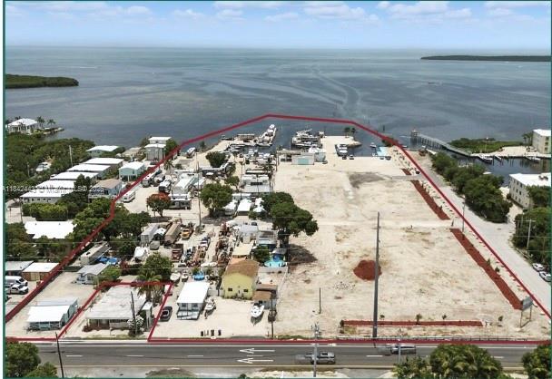 Seize this rare opportunity to develop one of the largest entitled waterfront parcels in the Florida Keys! This 7.34-acre assemblage offers 10 Total parcels, 54(57) ROGO exemptions, 15 transient rights, 30 wet slips and commercial SF. Multiple parcels sold as a package. Located oceanside at MM 97.5 with excellent visibility and access to boating and tourism. With flexible zoning across multiple land use districts (MU, SC, UR, URM), the site supports a wide variety of uses, including residential, vacation rentals, hospitality, RV park, Marina developement or boat storage. Whether you envision a boutique resort, waterfront rental community, or luxury mixed-use enclave, this is a truly one-of-a-kind investment opportunity in Monroe County.