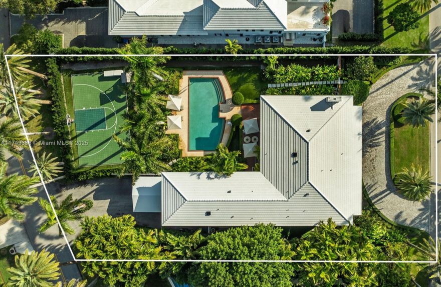 Nestled on exclusive guard-gated La Gorce Island, this exquisite colonial-style 2-story home has been meticulously renovated to blend timeless elegance with modern luxury. Boasting 6 bedrooms & 6.5 bathrooms across 5,472 square feet, the home sits on a 17,200 SF double-frontage oversized lot. This expansive home features a grand foyer, open kitchen to breakfast & family room w/ formal dining & living. Restored wood floors, a cozy fireplace and French doors bathed in natural light, offering serene views of the lush garden and pool. Outdoors complete w/ a half basketball court, and summer kitchen. The primary suite is a private retreat, including a sitting area, walk-in closet and a spa-like bath with separate tub & shower. This home offers unparalleled privacy, security and sophistication.