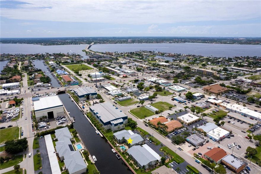 FIRST TIME ON MARKET IN 25+ YEARS! Live the FLORIDA DREAM at MARINA 46 *ASSIGNED DOCK INCLUDED!* – a RARE 1st-floor CORNER Gulf-access condo in SE Cape Coral! This 2BR/2BA boasts the largest floorplan, open design, & bright natural light. STUNNING UPDATES: modern tile, re-piped plumbing, new electrical panel, remodeled granite baths w/ ADA shower, newer A/C & water heater, stainless fridge, hurricane-impact glass, & lanai w/ breathtaking POOL & INTERSECTING CANAL VIEWS! Community POOL, BOAT SLIPS, storage, & covered parking included. Just ONE BRIDGE to the Caloosahatchee & Gulf – a BOATER’S PARADISE! Minutes to Sanibel, Captiva, Fort Myers Beach, Naples & more. A RARE GEM – ACT FAST!