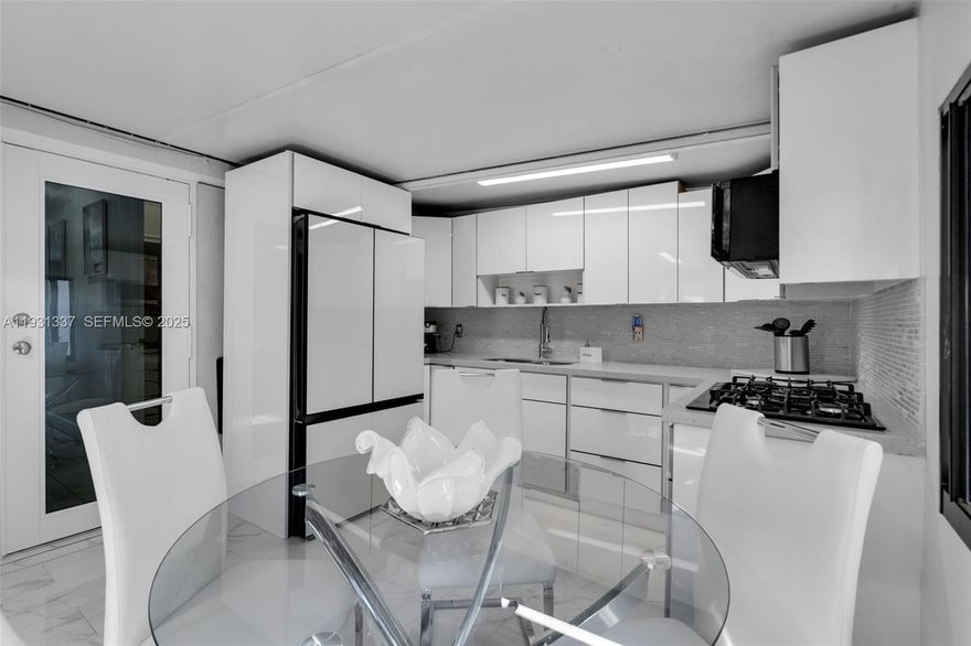 This move-in ready 3-bedroom, 2.5-bath home features an open-concept layout with high ceilings, recessed lighting, and sleek porcelain floors throughout. Bright and modern living/dining areas flow seamlessly into an updated kitchen with contemporary cabinetry and stainless-steel appliances. The home offers spacious bedrooms and fully renovated bathrooms with elegant tile and modern finishes.

Step outside to a private backyard oasis with a fully equipped outdoor kitchen, covered patio, and plenty of space for year-round entertaining. Additional features include a newly finished driveway with parking for multiple cars, updated windows/doors, and excellent curb appeal.

Located in the heart of Hialeah near shopping, dining, schools, and major highways. A rare opportunity to own a modernized home with exceptional indoor and outdoor living. A must-see!