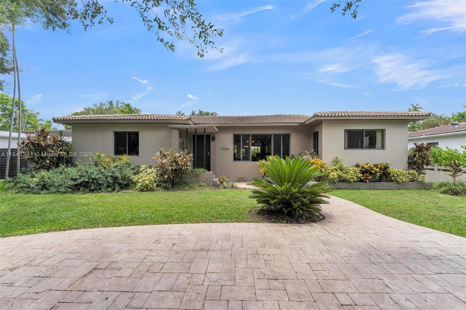 Miami Shores POOL home - East of Biscayne! This classic 3/2 gem is nestled on a tree-lined street in one of Miami Shores' most desirable pockets. Lovingly cared for & cherished by the same family for decades, the split floor plan features original wood floors, ceiling fans, impact windows, and a sun-drenched Florida room—perfect for relaxing or entertaining. The sparkling pool is surrounded by lush landscaping, creating your own tropical escape. The one-car garage offers flexibility for parking, storage, or expansion. Spacious layout with great natural light and a warm, welcoming vibe. Just a short stroll to wide-open Biscayne Bay & minutes to top-rated schools, restaurants, parks, beaches. A rare opportunity to own a true neighborhood classic!