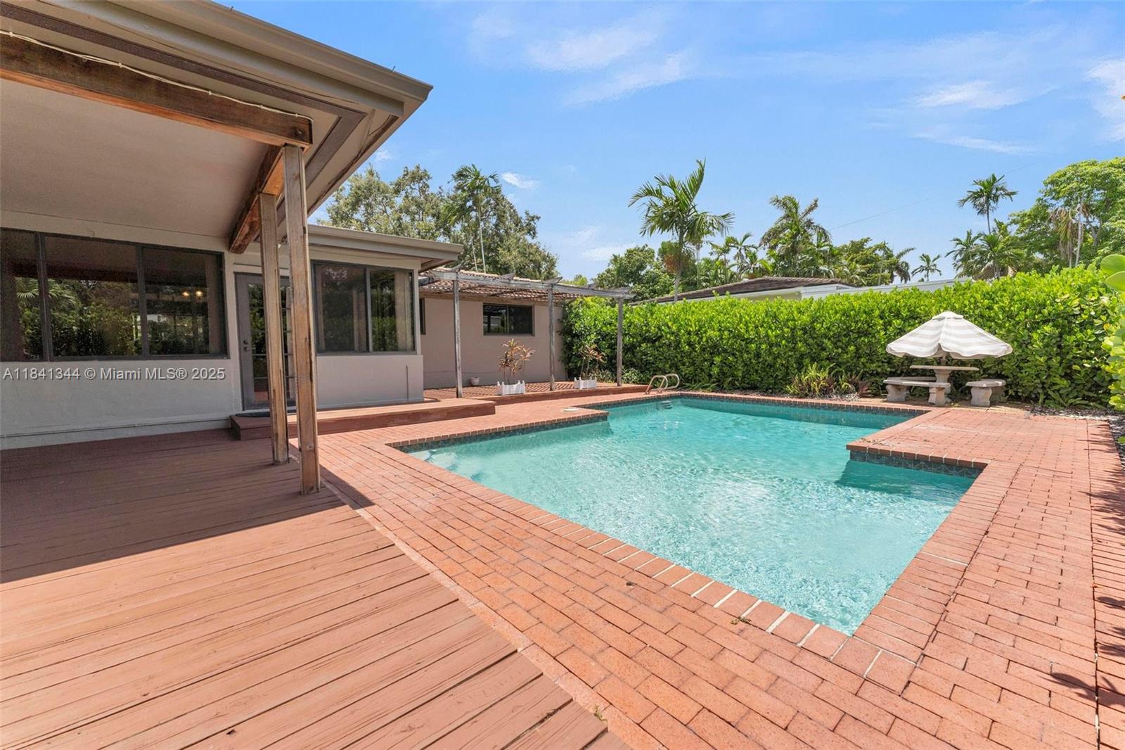 Create your own PRIVATE retreat in Miami Shores POOL home - East of Biscayne! This classic 3 bed/2 bath gem is nestled on a tree-lined street in one of Miami Shores' most desirable pockets. Lovingly cared for & cherished by the same family for decades, the split floor plan features original wood floors, ceiling fans, impact windows, and a sun-drenched Florida room—perfect for relaxing or entertaining. Lounge by the sparkling POOL & covered deck, surrounded by lush landscaping. The one-car garage offers flexibility for parking, storage, or expansion. Spacious layout (2200 Adj SF) with great natural light and a warm, welcoming vibe. Just a short stroll to wide-open Biscayne Bay & minutes to top-rated schools, restaurants, parks, beaches. A rare opportunity to own a true neighborhood classic!