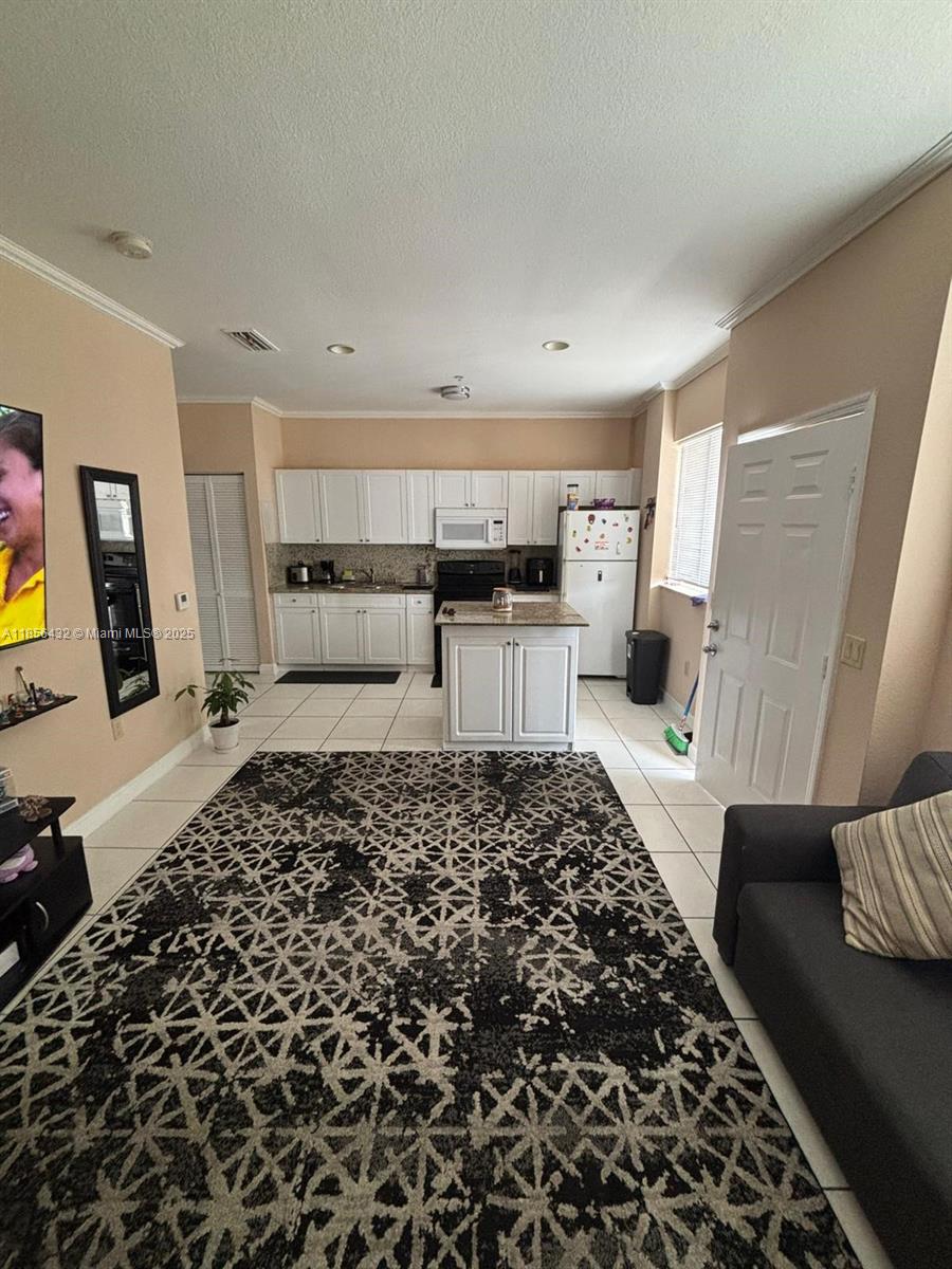Enjoy convenient amenities including an elevator, on-site laundry room, private gated parking (partially covered) with remote-controlled electric gate, mailbox, and weekly waste pick-up.
Inside, you’ll find central air conditioning, two spacious closets, a modern shower, glass-top range, granite countertops with full backsplash, an island breakfast bar, new cabinetry, and a fire safety system with sprinklers and alarms.
Utilities and internet are not included; the unit has separate electric and water meters for easy account setup with providers.