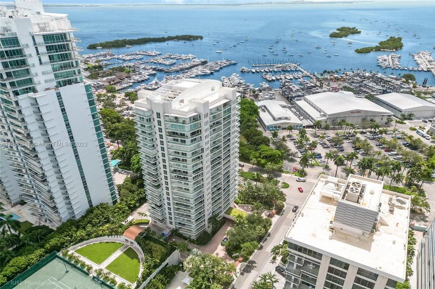 Rarely available large 1,910 SF residence at Grove Hill with stunning waterfront views. Enjoy the epitome of a Coconut Grove lifestyle with walkability to shops, restaurants, the waterfront & marinas, gyms, and grocery store. The building features very low turnover and fantastic amenities like a lap pool, 24-hour security with two front desk personnel, dog park, tennis & pickleball courts, playground, gym, sauna, and more. Inside the residence, you’ll relish the privacy of a corner unit with wraparound views and multiple balconies. Entertain family and friends with an eat-in kitchen with custom cabinetry and high-end appliances or in the open great room and dining room with built-in bar with 92-bottle wine chiller. Two assigned parking spaces and storage unit. Some photos virtually staged.