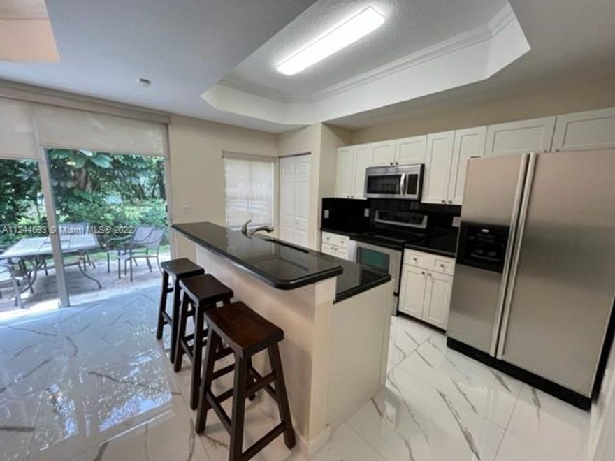 RARE! Don't miss this beautiful Coco Plum 3 bedroom, 2 1/2 bathroom corner unit townhouse with front lake views in gated community. This townhouse has been totally remodeled with new kitchen cabinets, granite counter tops, Whirlpool stainless steel appliances, Whirlpool washer & dryer, walk in master shower, first floor tile floors, second floor wood floors, hurricane panels, crown molding, paver entry & private patio area, walk in master closet, all built out closets, high base baseboards, recessed lighting, new A/C, community pool, separate washer/dryer utility room, eat in kitchen, kitchen island with seating, dining room, living room, plenty of windows & natural light, very clean and ready to move in. Unit has two assigned parking spaces. Fantastic location.