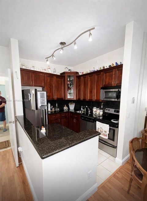 Photo of 7707 Ashmont Cir #214, Tamarac, FL 33321 (MLS # A11961334)