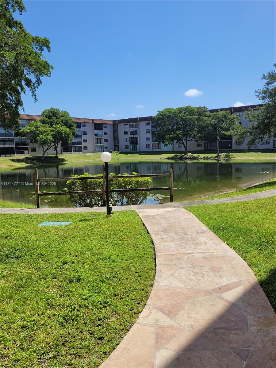 Welcome to Lakes of Carriage Hills. A must see, spacious 1,350 sf 2 bedroom/2 bath condo with a view of the lake. Tile flooring throughout and a recently updated European style kitchen with new appliances and custom cabinets. Private laundry/utility room has a full-size washer and dryer and a large storage closet. New modern vanities in both bathrooms. Walk-in closets in both bedrooms. There is no shortage of storage in this unit. Clubhouse is right across the street from Bldg 6. Maintenace includes water, cable w/HBO, internet, reserve fund & exterior insurance. Building has a new roof and new elevator. Current assessment to be paid off by seller. Enjoy all the community amenities, 2 heated pools, tennis, gym, billiards, shuffleboard and more. Well maintained & managed 55+ community.