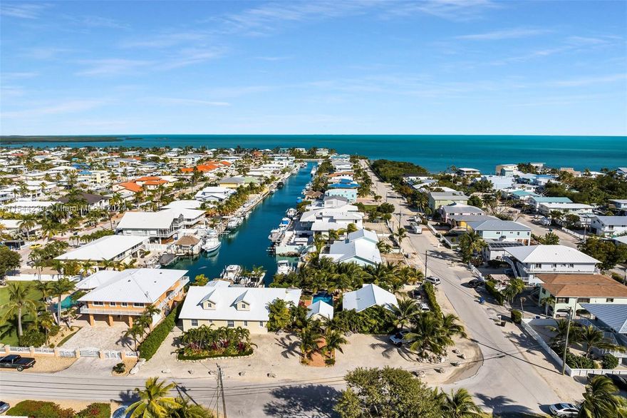 Welcome to 'Casa Unica''-waterfront luxury living at its finest! This recently built estate offers the perfect blend of Island elegance and sophisticated style in a private setting. Situated on a double lot spanning 18,014 sqft, this exceptional home boasts a host of desirable features and is in the exclusive community of Port Largo.With 4 bedrooms, 3.5 bathrooms, & a spacious floor plan spanning over 3,470 sqft, its a truly unique gem. Step inside and be greeted by the grand entrance- a beautifully designed courtyard with manicured landscape surrounding the perfectly positioned pool with sheer descent waterfall. The ground level offers a separate guest house with its own kitchenette, loft and bathroom, ensuring privacy and flexibility for guests or extended family.