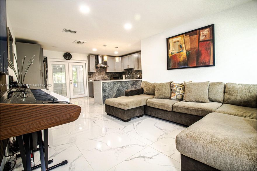 FHA buyers welcome! This beautifully remodeled house in Davie home also includes a private maid/in-law quarters—perfect for guests, home office, or rental income. Fully updated with a 1-year-old roof, impact windows, brand-new A/C, gas water heater, and new stainless-steel appliances including a gas range. Modern chef’s kitchen with quartz waterfall island, sleek porcelain floors, and open living spaces. Fenced backyard patio ideal for entertaining.