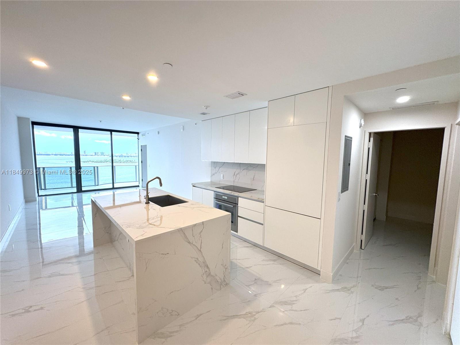 Stunning NEW BUILD 1 bedroom + den, 2 bath condo in luxurious Aria Reserve, in the popular Edgewater neighborhood! BRAND NEW, be the 1st to live in this home!! Modern designer finishes, elegant marble look porcelain floors, spacious island, premium appliances, and floor-to-ceiling windows that flood in natural light. Den is perfect for a home office or bedroom. Step out onto the expansive private balcony with breathtaking views of Biscayne Bay - perfect for a morning coffee while watching the sunrise. Enjoy access to world-class amenities including resort-style pools, a full-service spa, fitness center, tennis courts, 24-hour concierge, and a waterfront promenade. Perfectly situated minutes from Wynwood, Brickell, Downtown, and Miami Beach, this home offers unmatched luxury and convenience