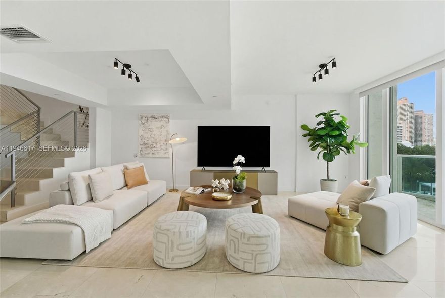 A stunning and elegant residence thoughtfully designed for both everyday comfort and effortless entertaining. Sun-filled main level features a home office, living room, formal dining room, large kitchen and laundry room all with beautiful intercoastal water and pool views. Upstairs offers two en-suite bedrooms plus a large den. This residence blends refined style with everyday livability. Residents enjoy world-class amenities: Two pools, spa, gym, steam room, sauna, tennis, barbecue and sunning decks with furniture and umbrellas, recreation room, 24-hour concierge, valet parking, and a manned gatehouse.