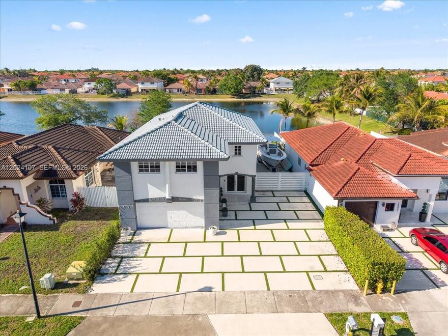 Welcome to this breathtaking 2-story lakefront home in the highly sought-after gated community of Caribe Lakes
Phase I! This stunning residence delivers approximately 2,480 square feet of sun-filled living space with 4 bedrooms, 3.5 bathrooms, and a 2-car garage. Step inside to discover a beautifully open split-floor-plan layout designed for both everyday living and effortless entertaining. The entire home features elegant tile flooring on both levels, soaring high ceilings, and an abundance of natural light. Downstairs, you’ll find a convenient powder room and direct access to the private backyard overlooking the sparkling lake — the perfect spot for morning coffee or evening relaxation. Upstairs, privacy reigns supreme. The expansive primary suite boasts a massive walk-in closet and luxurious bath, while the thoughtfully designed secondary bedrooms offer flexibility: two share a full bath, and the fourth features its own en-suite bathroom and closet. A dedicated laundry room completes the practical layout. With low HOA fees and lightning-fast approval (just 5–7 business days), this move-in-ready gem is the rare opportunity you’ve been waiting for. Don’t miss your chance to call this gorgeous lakeview home yours — schedule your private showing today!
