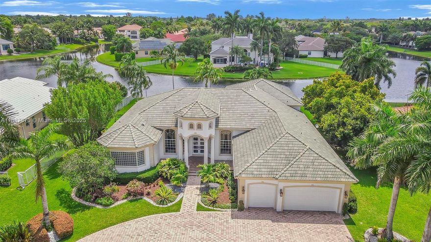 Discover refined elegance in this exceptional estate home, perfectly situated in the prestigious 24-hour guard-
gated community of Stonebrook Estates. This residence impresses w/ its grand curb appeal & beautifully paved
circular driveway. Lovingly maintained by its original owners, the home showcases breathtaking panoramic lake
views throughout. Featuring 5 bedrooms, 5.5 baths + an executive office. The thoughtfully designed triple-split
floor plan offers both privacy + functionality. The custom gourmet kitchen opens to light-filled living spaces.
Luxurious primary suite w/ a sitting area + dual walk-in closets. Step outside to a beautifully paved backyard oasis
complete w/ pool & serene lake views. Enjoy resort-style amenities including a clubhouse, tennis + tot lot.
A true gem!